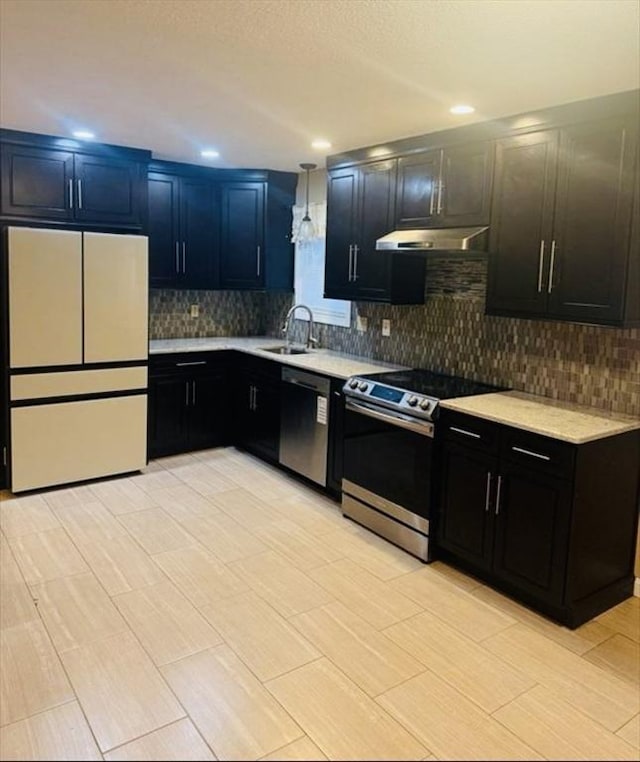 45 4th St, Worcester, MA 01602 - kitchen with stainless steel appliances, under cabinet range hood, light countertops, backsplash, and recessed lighting