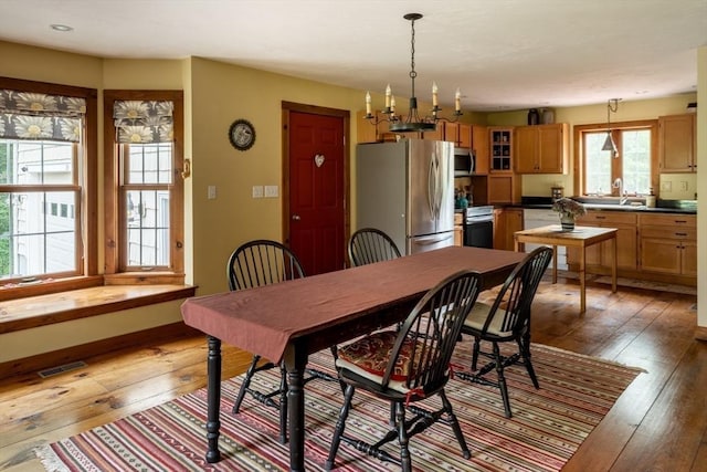 29 Miscoe Rd, Mendon, MA 01756 - dining space with light wood finished floors and a chandelier