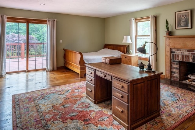 29 Miscoe Rd, Mendon, MA 01756 - bedroom featuring light wood-style floors, access to outside, and a brick fireplace