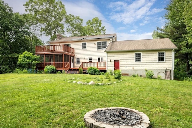 29 Miscoe Rd, Mendon, MA 01756 - rear view of property featuring a sunroom, a fire pit, a wooden deck, and a lawn
