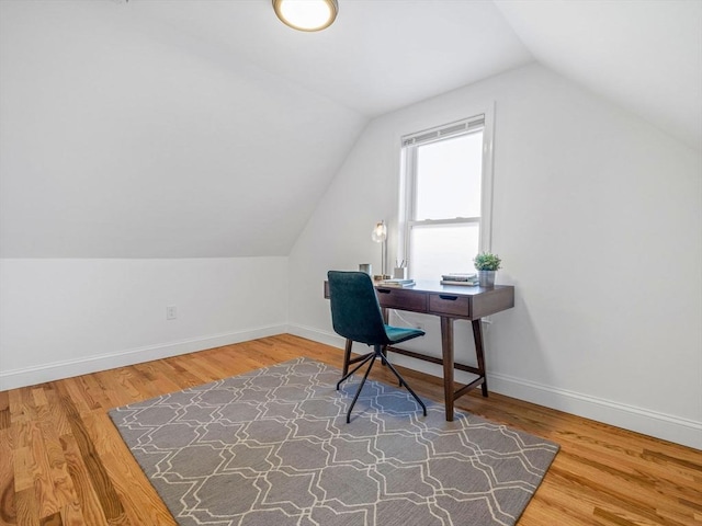 home office featuring vaulted ceiling and wood-type flooring