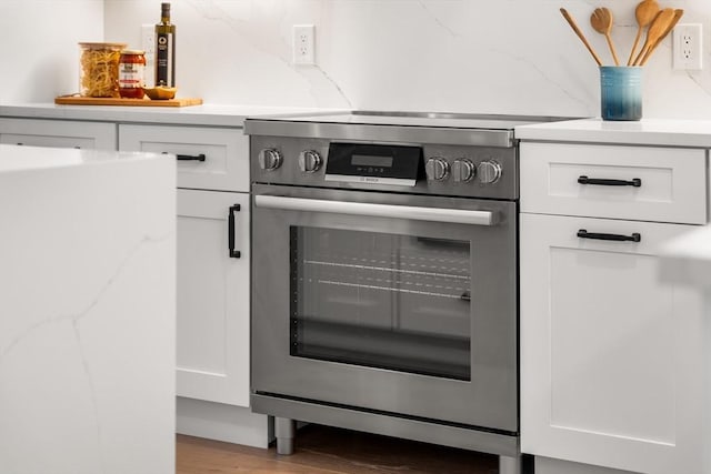 18 Franklin Unit 202, Salem, MA 01970 - kitchen view of electric stove, white cabinetry, and light wood-style floors