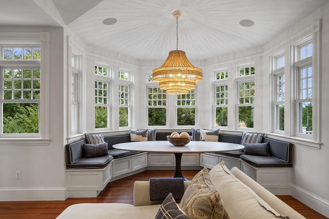 sunroom / solarium featuring a notable chandelier