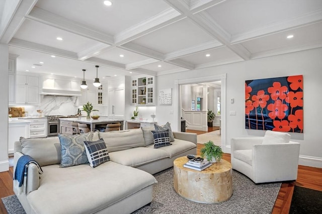 living area with baseboards, beam ceiling, coffered ceiling, and wood finished floors