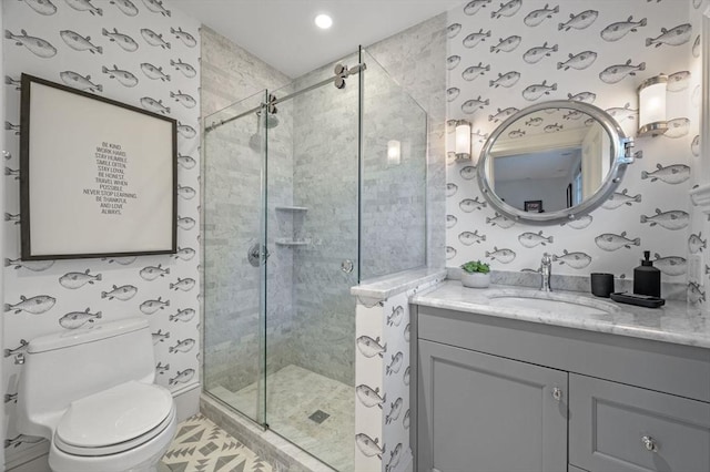 bathroom featuring vanity, toilet, a stall shower, and wallpapered walls