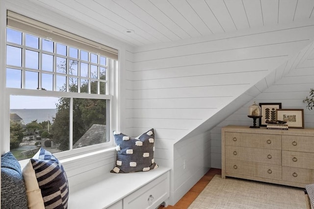 interior space featuring wooden ceiling, wood walls, and light wood-type flooring