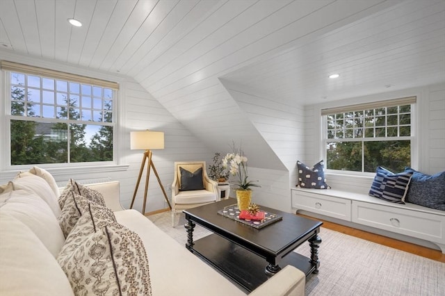 living area featuring lofted ceiling, light wood-style flooring, recessed lighting, and plenty of natural light