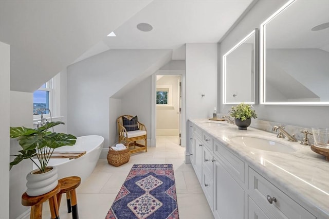 bathroom featuring a freestanding tub, a sink, and double vanity