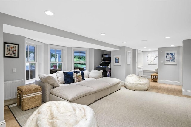 living room with radiator, light wood finished floors, and recessed lighting