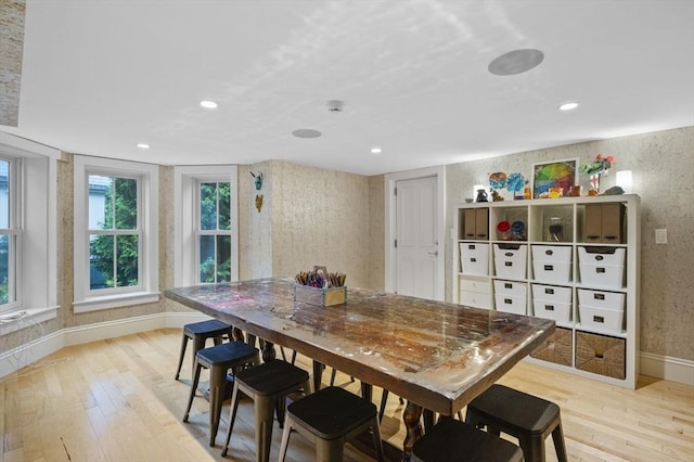dining room featuring baseboards, light wood finished floors, and recessed lighting