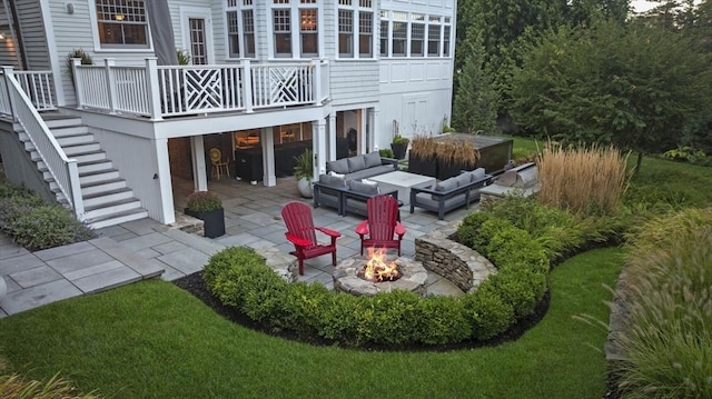 exterior space with an outdoor living space with a fire pit, stairs, a patio, and a wooden deck