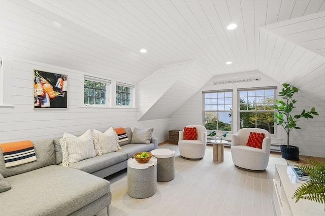 living room featuring vaulted ceiling, wood walls, plenty of natural light, and recessed lighting