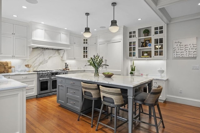 kitchen with double oven range, wood finished floors, gray cabinets, and white cabinets