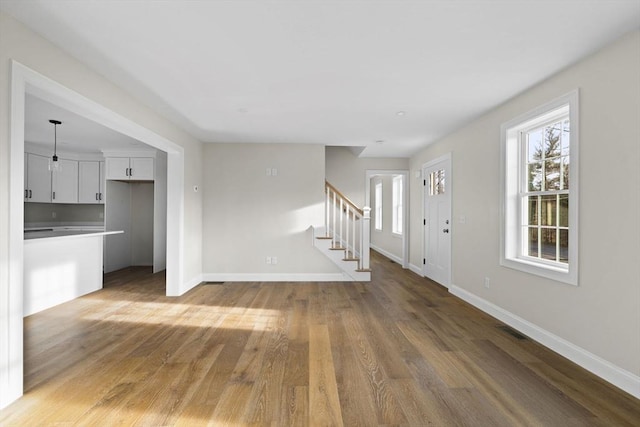 unfurnished living room with hardwood / wood-style floors