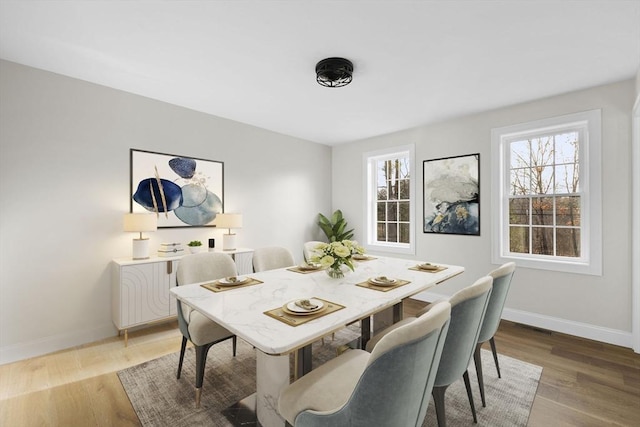 dining space with hardwood / wood-style flooring