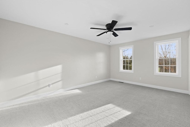 empty room featuring carpet flooring and ceiling fan