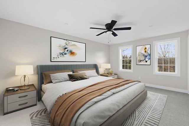 bedroom with ceiling fan and light colored carpet