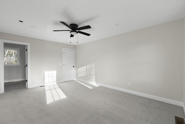 unfurnished bedroom featuring light colored carpet and ceiling fan