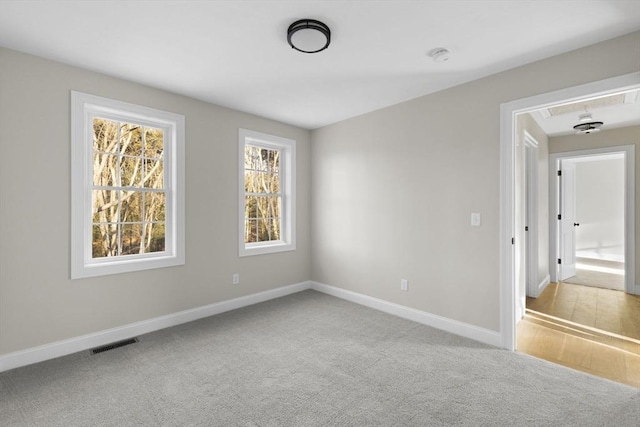 unfurnished room with light carpet