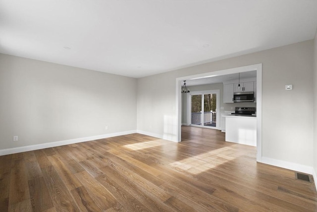 empty room with hardwood / wood-style floors