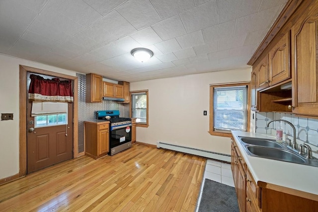 2 Hammond Ct, Quincy, MA 02169 - kitchen with stainless steel gas range, baseboard heating, a sink, brown cabinets, and light wood finished floors