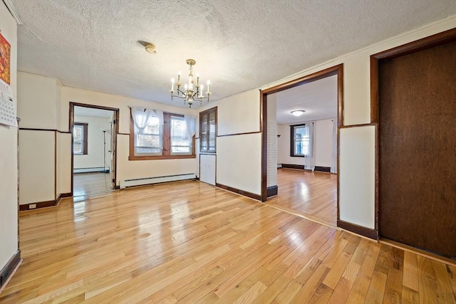 2 Hammond Ct, Quincy, MA 02169 - unfurnished dining area with baseboard heating, a chandelier, a textured ceiling, light wood-type flooring, and baseboards