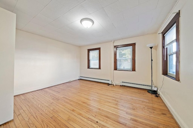 2 Hammond Ct, Quincy, MA 02169 - spare room with a baseboard heating unit, light wood-style flooring, and healthy amount of natural light