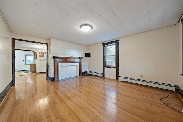 2 Hammond Ct, Quincy, MA 02169 - unfurnished living room featuring a baseboard radiator, wood-type flooring, and plenty of natural light