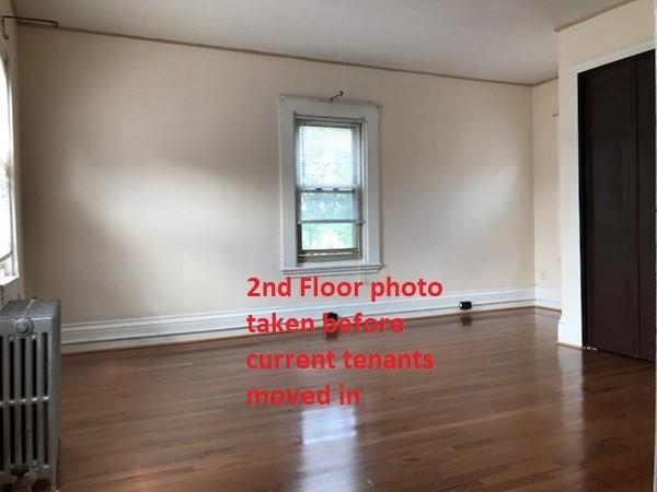 2 Hammond Ct, Quincy, MA 02169 - empty room with radiator, wood finished floors, and baseboards