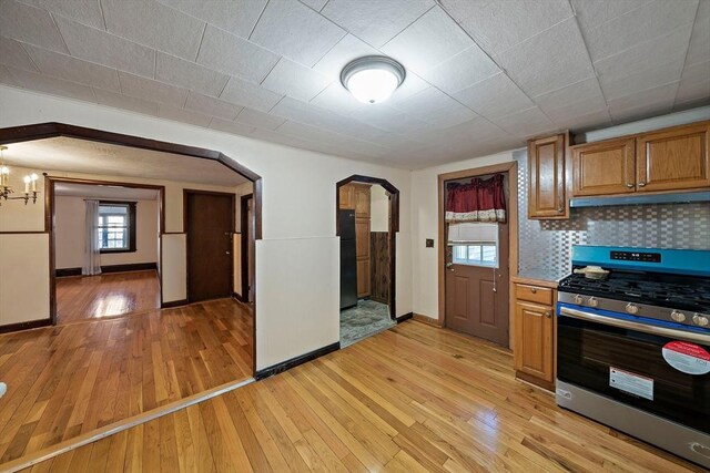 2 Hammond Ct, Quincy, MA 02169 - kitchen featuring stainless steel gas stove, arched walkways, and light wood-style floors