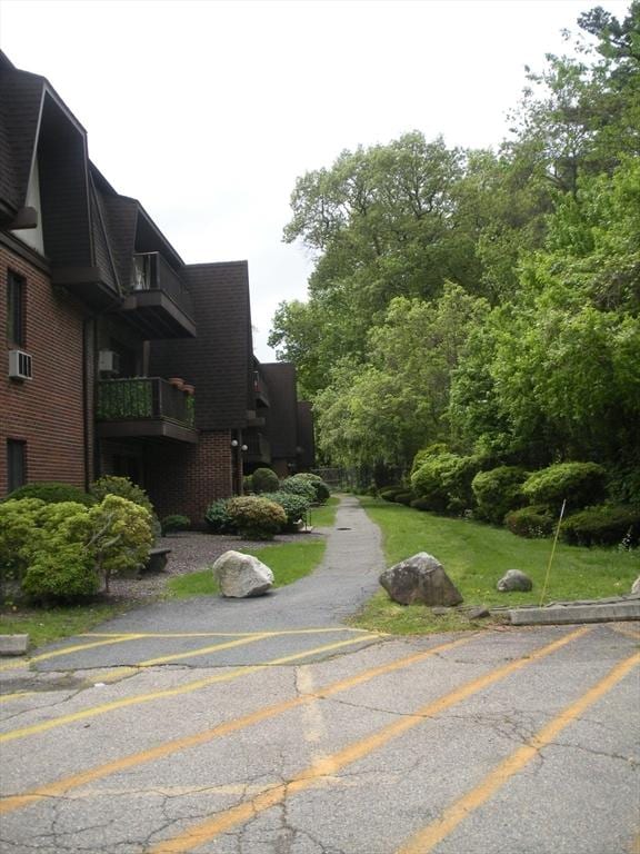 47 W St Unit A2, Randolph, MA 02368 - view of property exterior with brick siding and a balcony