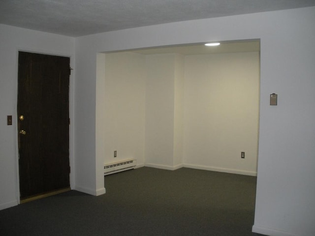 47 W St Unit A2, Randolph, MA 02368 - empty room featuring baseboard heating, dark carpet, and baseboards