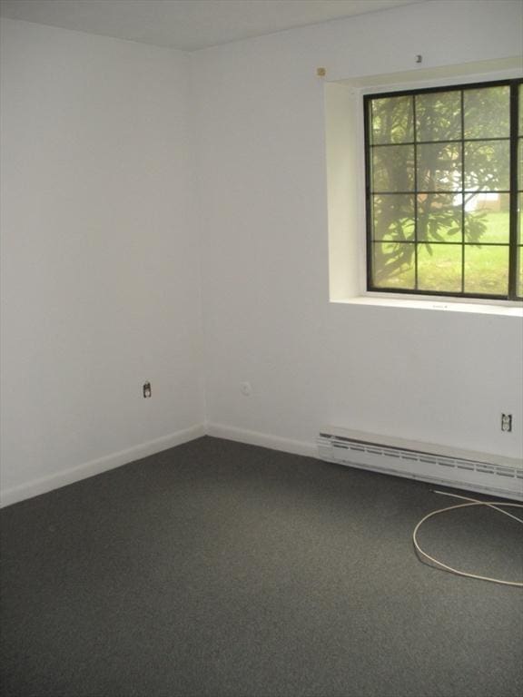 47 W St Unit A2, Randolph, MA 02368 - carpeted empty room with a baseboard heating unit and baseboards