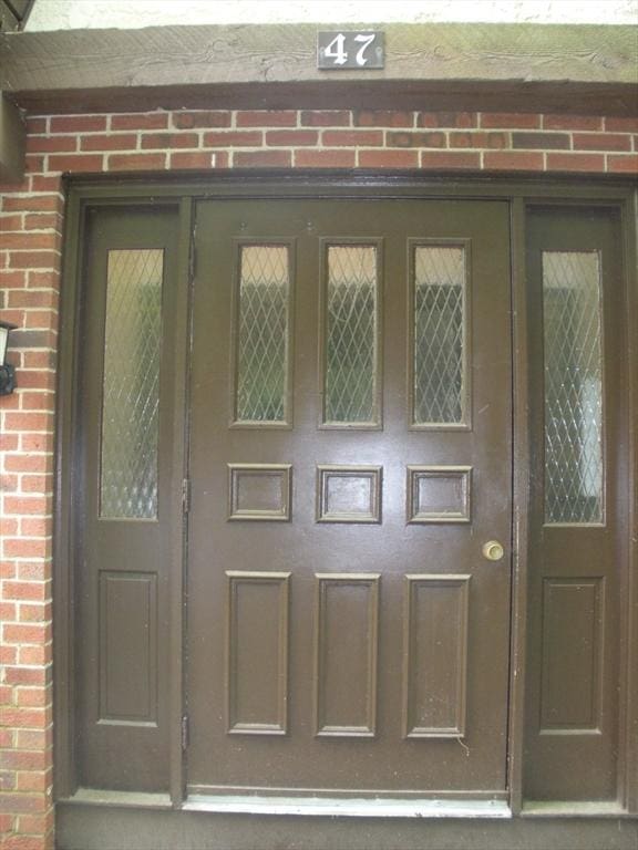 47 W St Unit A2, Randolph, MA 02368 - doorway to property with brick siding
