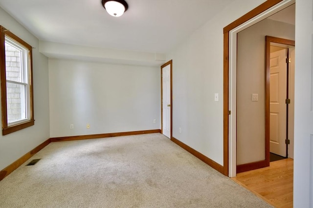 39 Bellis Cir Unit E, Cambridge, MA 02140 - unfurnished room featuring baseboards, visible vents, and light colored carpet