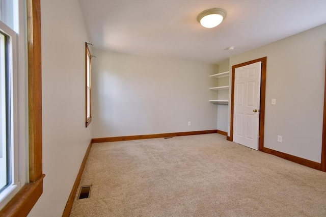 39 Bellis Cir Unit E, Cambridge, MA 02140 - carpeted spare room featuring visible vents, baseboards, and plenty of natural light