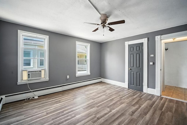 16 Laurel St, Springfield, MA 01107 - unfurnished bedroom with a baseboard heating unit, wood finished floors, a textured ceiling, cooling unit, and a ceiling fan