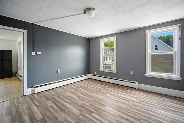16 Laurel St, Springfield, MA 01107 - spare room with a baseboard radiator, wood finished floors, a textured ceiling, and cooling unit