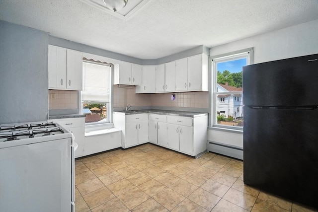 16 Laurel St, Springfield, MA 01107 - kitchen with freestanding refrigerator, a baseboard radiator, white gas range oven, backsplash, and a textured ceiling