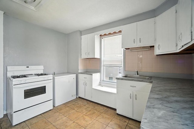 16 Laurel St, Springfield, MA 01107 - kitchen with white gas stove, backsplash, white cabinetry, and light countertops