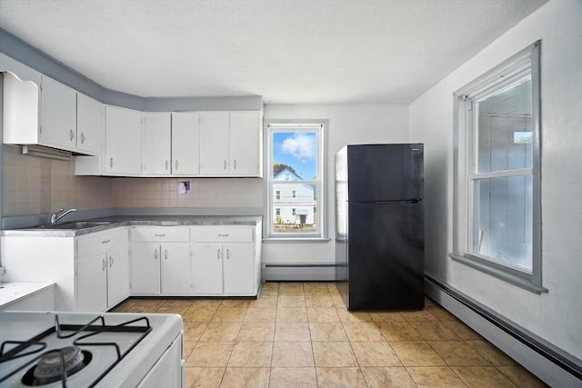 16 Laurel St, Springfield, MA 01107 - kitchen featuring freestanding refrigerator, baseboard heating, a baseboard radiator, white cabinetry, and a textured ceiling