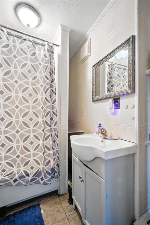 16 Laurel St, Springfield, MA 01107 - bathroom with vanity, tile walls, a shower with shower curtain, a textured ceiling, and tile patterned floors
