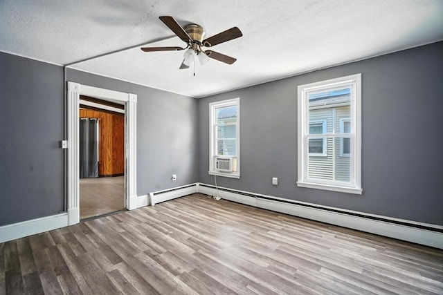 16 Laurel St, Springfield, MA 01107 - unfurnished room with ceiling fan, wood finished floors, baseboard heating, cooling unit, and a textured ceiling