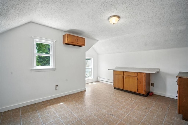 16 Laurel St, Springfield, MA 01107 - bonus room with vaulted ceiling, a baseboard heating unit, and a textured ceiling