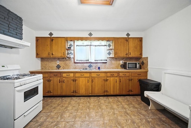 16 Laurel St, Springfield, MA 01107 - kitchen featuring gas range gas stove, stainless steel microwave, brown cabinets, and light countertops