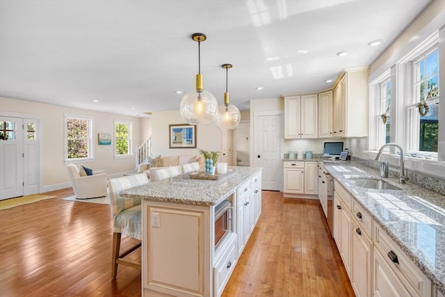 27 Watcha Path, Edgartown, MA 02539 - kitchen with a kitchen breakfast bar, open floor plan, appliances with stainless steel finishes, light wood-type flooring, and recessed lighting