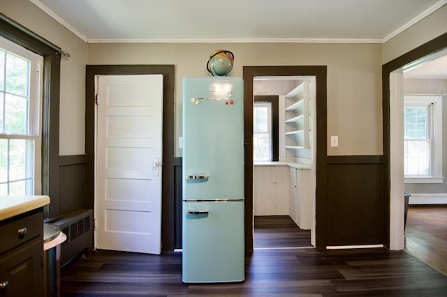 31 E St, Stafford, CT 06076 - foyer featuring radiator heating unit, a wainscoted wall, dark wood-type flooring, and ornamental molding