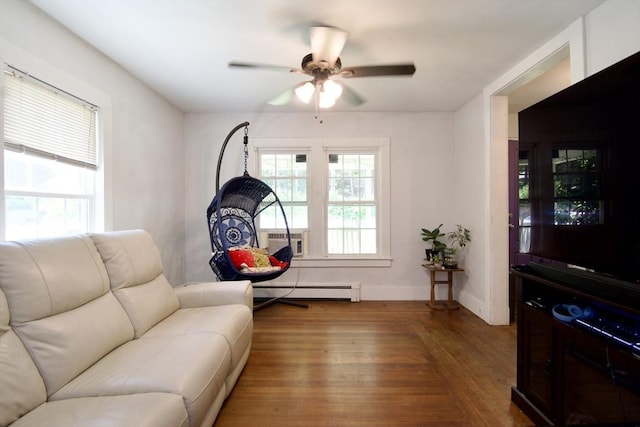 31 E St, Stafford, CT 06076 - living area featuring wood finished floors, cooling unit, a baseboard heating unit, and ceiling fan