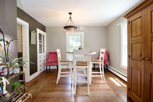 31 E St, Stafford, CT 06076 - dining room featuring a baseboard heating unit and wood finished floors