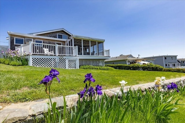 113 N Ridge Rd, Ipswich, MA 01938 - back of house with a sunroom, a wooden deck, and a lawn